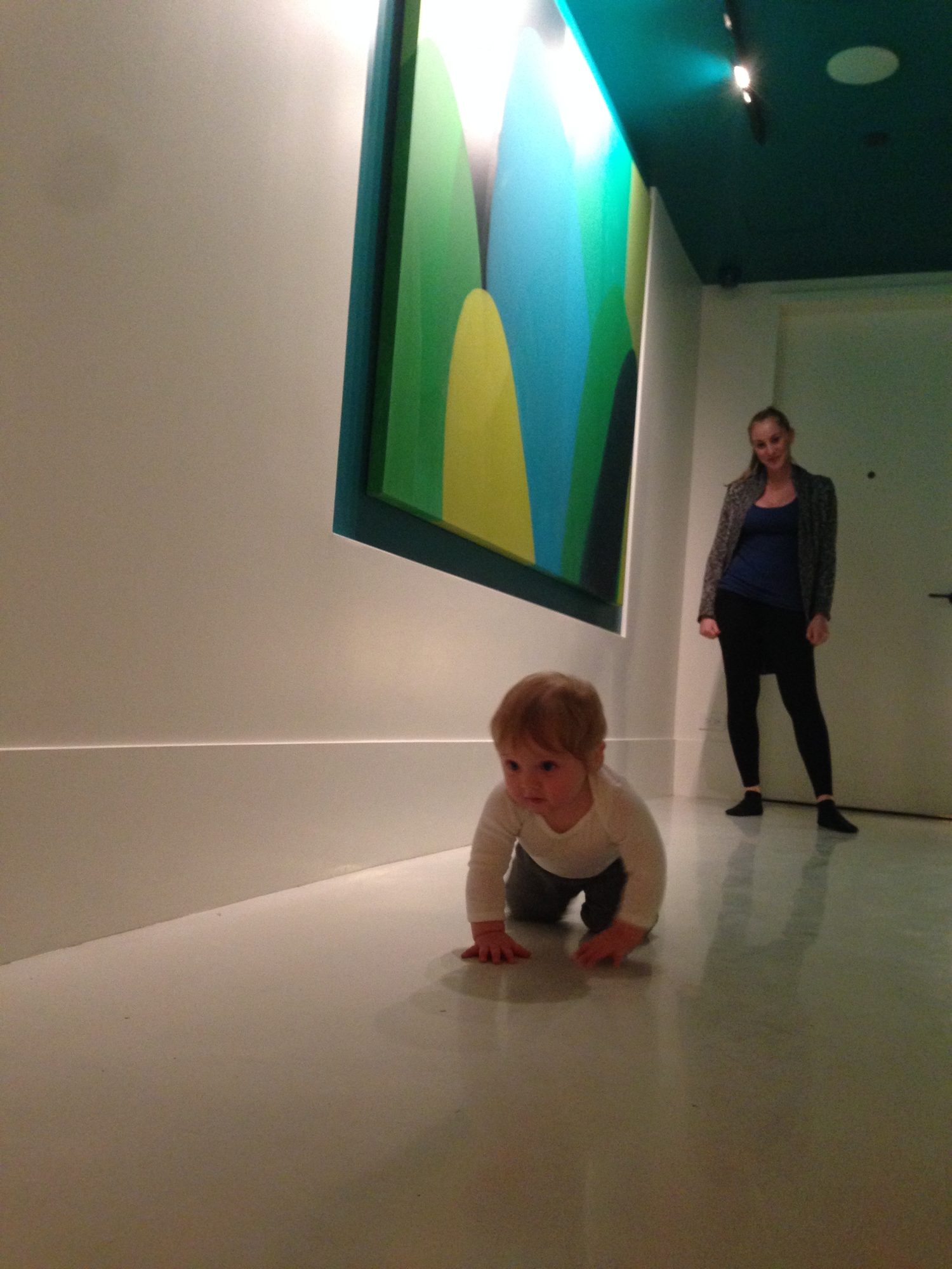 Michael Fuller's son Sage, about a year old, crawling across the gallery-white floor at The William during the December 2013 opening.