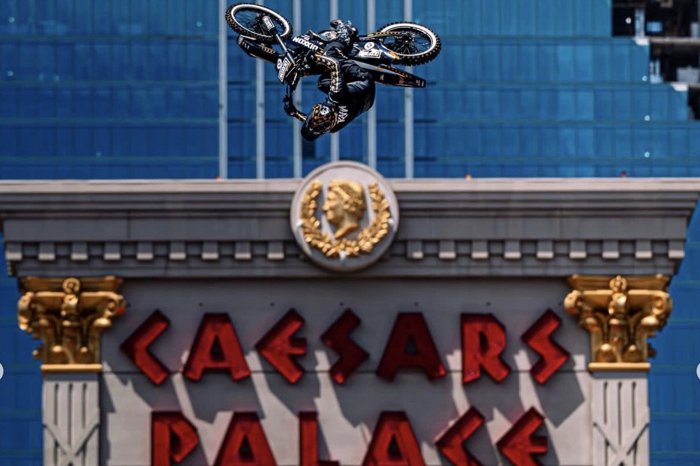 Colby Raha inverted mid-air above the Caesars Palace sign during the world-record motorcycle jump, Las Vegas, May 2026.