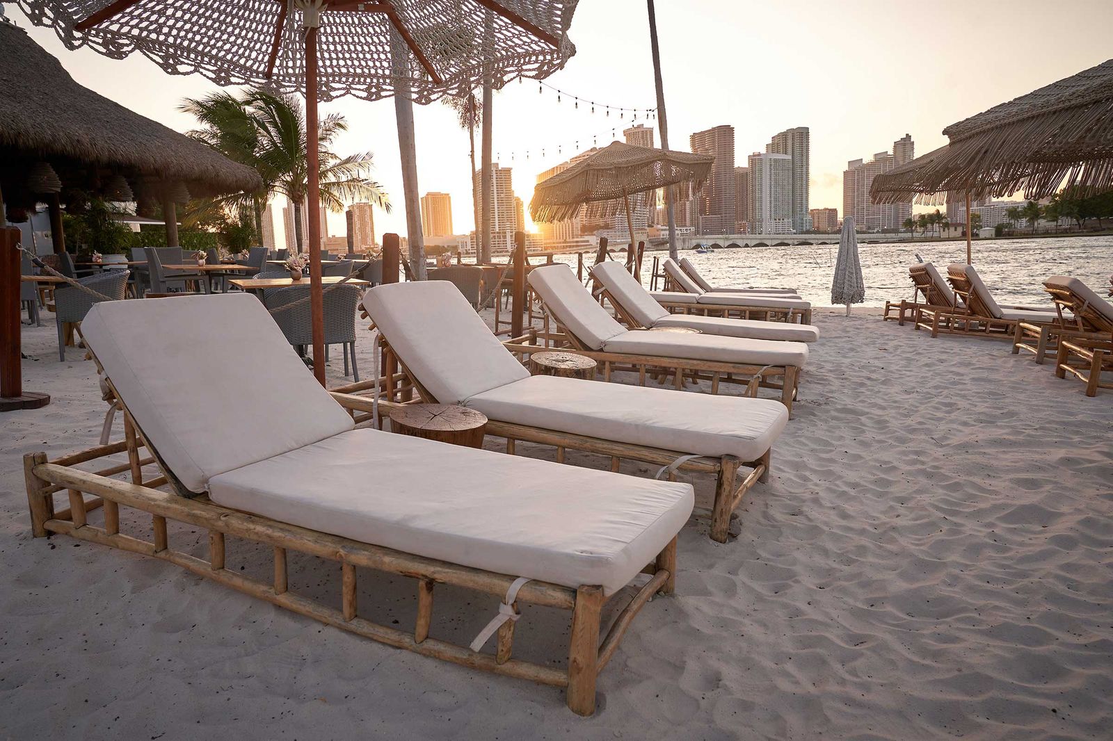 JOIA Beach, the restaurant and beach club on the Jungle Island waterfront, with the Miami skyline behind it.