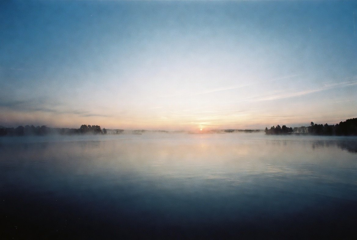 Sunrise over still water, mist on the surface — the quiet-morning image behind I Talk With God.